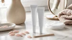 Nail glue tubes with press-on nail tips and a wood applicator