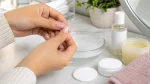 Nail glue skin cleanup with warm soapy water and cotton pads